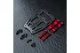 MST carbon fiber front suspension arm mount set with red anodized aluminum components and black screws on a textured black surface.