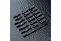 A set of black MST RC turnbuckles and rod ends arranged on a dark textured surface.