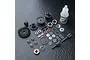 MST Limited Slip Differential gear set components including gears, bearings, shims, screws, and a bottle of 3000# gear diff oil on a black textured surface.