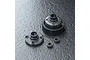 MST bevel gear differential set components including a large gear housing, a circular cover plate, and two small ball bearings on a dark textured surface.