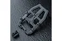 A black MST front head set component for an RC car chassis, shown on a dark textured surface.
