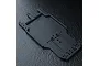 Black MST RMX series RC car rear lower deck chassis plate on a dark textured surface.