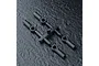 Four black plastic RC rod ends attached to a sprue tree on a dark textured background.