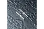 Two silver metal drive pins with a flat notch in the center, positioned diagonally on a dark textured surface.