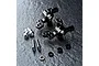 A set of black MST Aluminium ATK V3 steering hubs with included hardware, including ball studs, screws, and spacers on a dark textured surface.