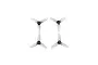 Four clear three-blade propellers for FPV drones arranged in a square pattern against a black background.
