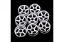 A set of eight white plastic RC car rims with a five-spoke design arranged on a black background.