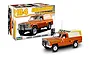 Revell 1/24 scale 1979 Jeep J-10 Pickup with Camper model kit, showing the assembled orange truck model next to its illustrated product box.