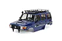 A royal blue RGT 1/10 scale LC76 Rescuer RC crawler body shell with a black roof rack, snorkel, and detailed decals against a white background.