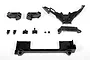 A collection of black plastic RC chassis components for the Axial Yeti, including suspension mounts, a brace, and a battery tray.