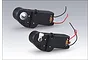 Two Heng Long RC tank gun barrel elevation motor units with black plastic housings and red and black electrical wires.