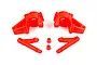 A set of bright red nylon RC car front steering hubs and associated suspension arms on a white background.