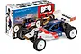Team Associated RC10 4WD Factory Team 1/10 scale electric buggy kit in front of its colourful product packaging box.