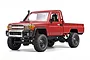 Studio shot of the MN Model Toyota LC79 1/12 scale RC rock crawler in red against a white background.
