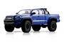 Studio product photo of a blue FMS FCX24M Toyota Tacoma RC rock crawler truck on a white background.