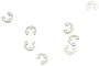 A collection of seven small silver metal E-clips scattered on a white background.