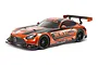 Studio product photo of Tamiya TT-02 Mercedes-AMG GT3 EVO RC car in orange and black livery on white background.