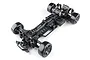 Top-down studio shot of the MST RMX 4 GT competition-level RC drift car chassis kit in black with carbon fiber components.