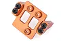 An orange anodized aluminium servo mount for an HSP Kulak RC crawler, featuring black Phillips head screws, set against a plain white background.
