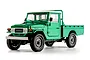 Studio shot of the FMS Toyota FJ45 RC rock crawler in green with a white roof and flatbed.