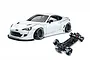 MST 86RB white RC drift car body with wide body kit alongside its black chassis on a white background