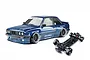 Dark blue E30RC drift car body with Pandem decals alongside its black RC chassis on a white background
