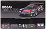 Tamiya 1/24 scale Nissan R390 GT1 plastic model kit box art showing the racing car and model parts.