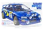 Tamiya 1/24 scale Subaru Impreza WRC '98 Monte-Carlo plastic model kit box art showing a blue rally car with gold wheels and auxiliary night lights.