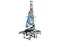 Joysway Binary V3 mini RC catamaran sailboat resting on a black plastic display stand against a white background.