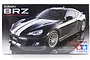 Tamiya 1/24 scale Subaru BRZ Street-Custom plastic model kit box art showing a black sports car with white racing stripes.