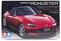 Tamiya 1/24 Mazda Roadster MX-5 plastic model kit box art showing a red convertible sports car on a black background.
