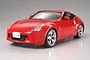 A studio shot of a finished Tamiya 1/24 scale Nissan Fairlady 370Z plastic model car in red, shown from a front three-quarter angle.