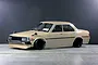 Pandora RC Toyota Corolla KE70 RC drift car body shell painted beige with black wheels on a studio floor.