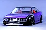 Front three-quarter view of a purple RC drift car body installed with a detailed interior set, intercooler, and front-end detailing.