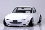 Front three-quarter view of a white Pandora RC Mazda Eunos Roadster NA RC drift car body shell on a reflective surface.