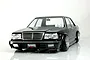 Front three-quarter view of a black Pandora RC Y31 Cedric sedan body shell with custom wheels against a white background.