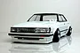 A painted white Pandora RC Toyota Mark 2 GX71 body shell mounted on an RC chassis with deep-dish wheels against a white background.