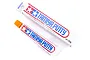 Tamiya Basic Type Putty 32g tube and its cardboard packaging box, featuring the Tamiya logo and red and blue branding on a white background.