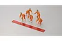Five small plastic figurine figures in orange jumpsuits with a red adhesive strip on a grey background.