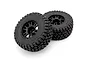 Two black RC monster truck tyres mounted on black multi-spoke rims against a clean white background.