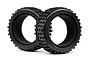 Two black rubber RC monster truck tyres with block tread patterns and internal foam inserts against a white background.