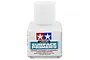 A bottle of Tamiya Liquid Surface Primer White, featuring a white screw cap and a label with the Tamiya logo and safety warnings.