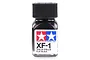 A small glass bottle of Tamiya XF-1 Flat Black enamel paint with a black screw-top lid against a white background.
