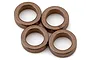 A close-up studio shot of four copper-coloured metal bushings arranged in a cluster against a plain white background.
