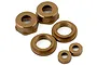 A set of gold-coloured aluminium shock caps and associated small threaded components for RC vehicles on a white background.