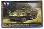 Tamiya 1/48 scale U.S. M20 Armored Utility Car plastic model kit box art showing an olive drab armored vehicle with two crew members in a forest setting.