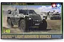 Tamiya 1/48 scale Japanese Komatsu Light Armored Vehicle plastic model kit box art showing the vehicle in a field.