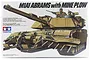 Box art for Tamiya 1/35 scale M1A1 Abrams tank model kit with mine plow, featuring an illustration of the tank and two crew members.