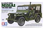 Tamiya 1/35 scale M151A1 Vietnam War U.S. Utility Truck plastic model kit box art showing a green military vehicle with a driver figure.
