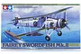 Tamiya 1/48 scale Fairey Swordfish Mk.II plastic model kit box art featuring a biplane flying over an aircraft carrier.
